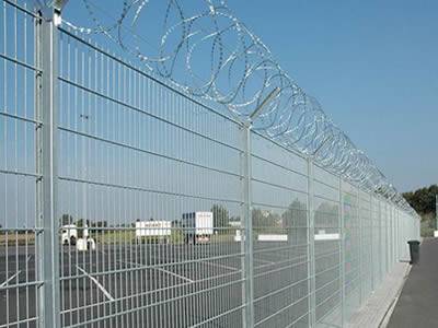 Several galvanized welded anti-intruder fences are installed in the parking lot.