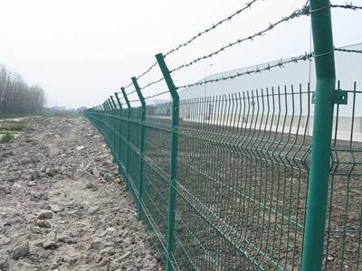 3D security fence panels with barbed wires are installed in the construction site.
