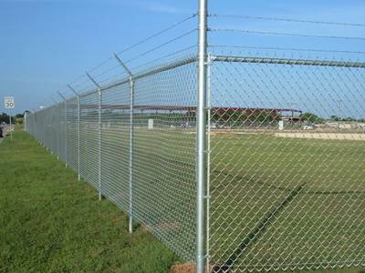 Chain link fences with barbed wires are installed on the grassland.