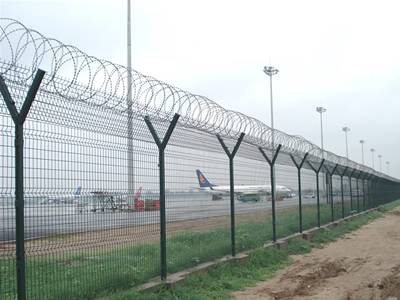Concertina razor wires are installed at the top of airport fence.