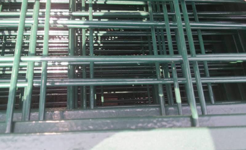 Dark green powder painted welded steel fences.