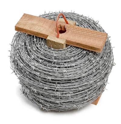 A roll of barbed wire with wooden roller and rope handle.