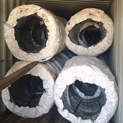 A forklift is loading the concertina razor wire into container.