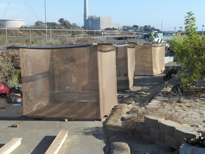 Three copper alloy crimped aquaculture mesh on the ground.