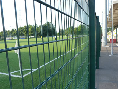 A green PVC coated double wire fence is installed at football field.