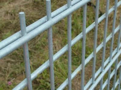 A galvanized double wire fence is installed for protecting farm land