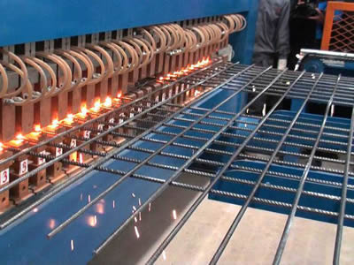 A machine is producing concreted welded wire mesh.