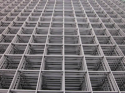 A bundle of welded wire mesh made of steel wires on the ground.