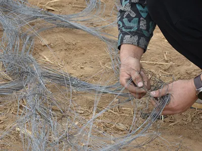 Worker installing obstacles fence