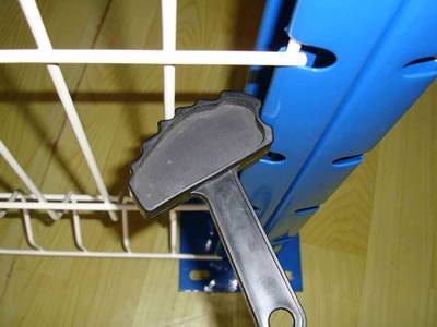 A black plastic tools is places on the fence panel.