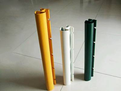 A yellow, a white and a green PVC coating peach post on the ground.