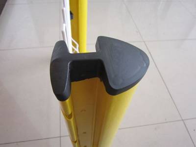 A black color plastic rain cap is installed on the yellow peach post.