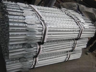 Three bundles of galvanized T studded posts on the ground.