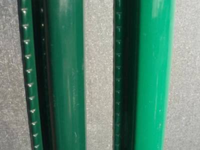 A dark green and a grass green posts on the ground.