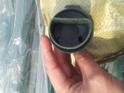A hand is holding a rain cap.