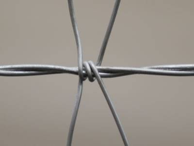A detail of V mesh of woven wire cattle fence.