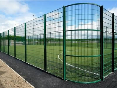 A green PVC coated welded fence with round corner is used as a football field fence.