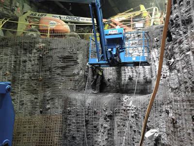 Several machines are operating for the tunneling construction, welded wire mesh is applied on the tunneling surface.