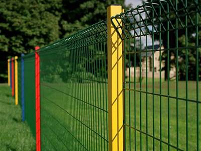 Green color roll top fences are installed in the garden with red and yellow square posts.