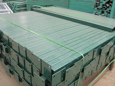 A bundle of square posts with flange on the ground.