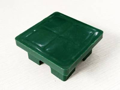 A green color plastic post cap on the white background.