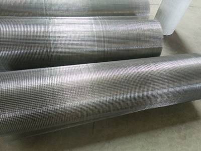 Three rolls of square welded wire mesh on the ground