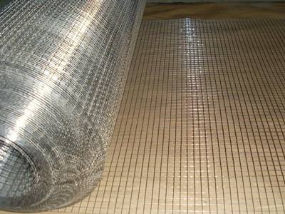 A roll of stainless steel welded wire mesh on the work platform, one section unfolded.