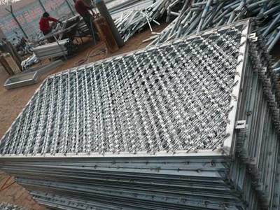 A bundle of straight razor wire fence with frame on the ground.
