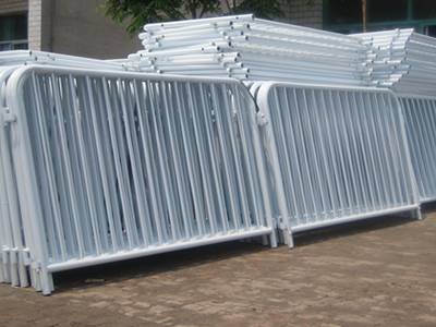 Several pieces of crowd control barriers on the ground.