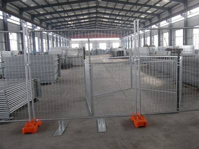 Several pieces of welded wire temporary fences are installed in the workshop.
