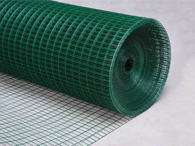 A roll of green color PVC coating welded mesh on the gray background.