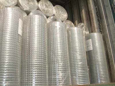 Welded mesh in plastic film package and loaded in container
