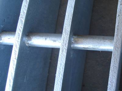 Swage locked welded steel grating on the ground.