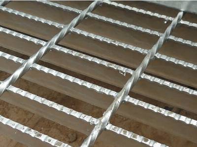 Serrated surface welded steel grating on the ground.