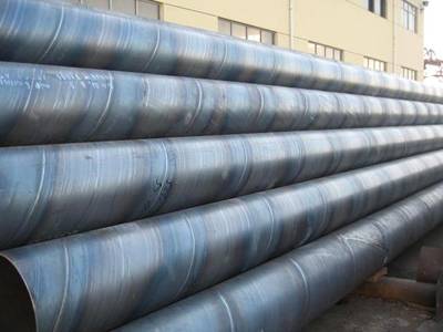 A stack of welded steel pipe on the ground.