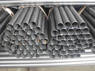 Several bundles of steel pipes on the ground.
