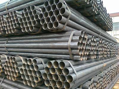 Several bundles of steel pipes are piled up.