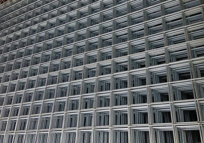 Several pieces of iron welded wire mesh on the ground.