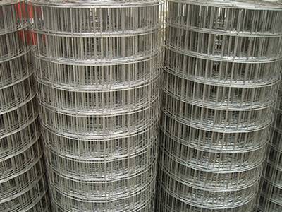 Several welded wire mesh rolls on the ground.